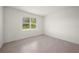 Bedroom with window, neutral walls, and tile flooring at 24041 Peppercorn Rd, Punta Gorda, FL 33955