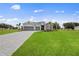 Attractive single-story home with stone accents, a two-car garage, and lush green lawn at 24041 Peppercorn Rd, Punta Gorda, FL 33955