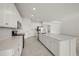 Bright kitchen featuring white cabinets, stainless steel appliances, a large island, and tile flooring at 24041 Peppercorn Rd, Punta Gorda, FL 33955