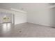 Open concept living space with neutral tile flooring and french doors leading to the outdoors at 24041 Peppercorn Rd, Punta Gorda, FL 33955