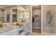 Elegant bathroom with double vanity, granite countertops, and a walk-in closet at 29513 Velletri Ln, Wesley Chapel, FL 33543