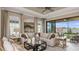 Bright living room with a ceiling fan and sliding glass doors that leads to the lanai at 29513 Velletri Ln, Wesley Chapel, FL 33543