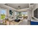 Bright living room with wood floors, stylish sofas, and an open design leading to the patio, perfect for relaxation and entertaining at 29525 Velletri Ln, Wesley Chapel, FL 33543