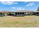 Home exterior with a sunroom addition in a sprawling lawn at 312 Fairside Ct # 12, Sun City Center, FL 33573