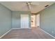 This bedroom has neutral carpet, a ceiling fan, and access to a closet and a bathroom at 312 Fairside Ct # 12, Sun City Center, FL 33573