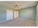 This comfortable bedroom has neutral carpet, a ceiling fan, and a closet with double doors at 312 Fairside Ct # 12, Sun City Center, FL 33573