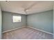 Comfortable bedroom features neutral carpet, a ceiling fan, and a window for natural light at 312 Fairside Ct # 12, Sun City Center, FL 33573