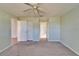 Comfortable bedroom shows neutral carpet, ceiling fan, and leads to a hallway and bathroom at 312 Fairside Ct # 12, Sun City Center, FL 33573