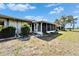 Home exterior with a sunroom addition and a lawn at 312 Fairside Ct # 12, Sun City Center, FL 33573