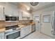 The kitchen features stainless steel appliances, ample counter space, and white cabinets at 312 Fairside Ct # 12, Sun City Center, FL 33573