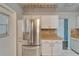 This stainless-steel refrigerator complements the kitchen's white cabinetry and wooden countertops at 312 Fairside Ct # 12, Sun City Center, FL 33573