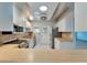 The kitchen has white cabinetry, stainless steel appliances, and a decorative tin ceiling at 312 Fairside Ct # 12, Sun City Center, FL 33573