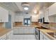 This kitchen has modern appliances, white cabinets, and stylish backsplash at 312 Fairside Ct # 12, Sun City Center, FL 33573