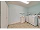 Laundry room with cabinets, washer, and dryer at 312 Fairside Ct # 12, Sun City Center, FL 33573