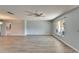 Spacious living room featuring modern flooring, a ceiling fan, and ample natural light from a large window at 312 Fairside Ct # 12, Sun City Center, FL 33573