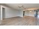 Expansive living room featuring modern flooring, a ceiling fan, and mirrored accents that enhance the spacious atmosphere at 312 Fairside Ct # 12, Sun City Center, FL 33573