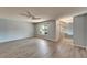 Bright and airy living room showcasing modern flooring, a ceiling fan, and a large window with pleasant views at 312 Fairside Ct # 12, Sun City Center, FL 33573