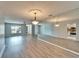 Spacious living room with modern flooring, a ceiling fan, and a mirrored wall, creating an open and airy feel at 312 Fairside Ct # 12, Sun City Center, FL 33573