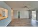 Open living room with light hardwood floors, neutral walls, and screened-in porch access at 312 Fairside Ct # 12, Sun City Center, FL 33573