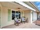 Cozy patio area with striped chairs, providing a relaxing space to enjoy the neighborhood and natural light at 312 Fairside Ct # 12, Sun City Center, FL 33573