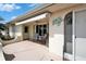 Inviting outdoor patio with comfortable seating under a retractable awning, perfect for relaxation and enjoying the surroundings at 312 Fairside Ct # 12, Sun City Center, FL 33573
