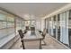Bright sunroom with tile flooring, a table and chairs, plus multiple windows at 312 Fairside Ct # 12, Sun City Center, FL 33573