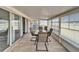 Bright sunroom with tile flooring, a table and chairs, and sliding doors at 312 Fairside Ct # 12, Sun City Center, FL 33573