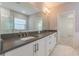 Bathroom with double vanity, granite countertops, and a large mirror at 324 37Th Ne Ave, St Petersburg, FL 33704