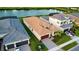 Single-story home with a two-car garage, a well-manicured lawn and a brick paved driveway at 32768 Tree Of Life Ave, Wesley Chapel, FL 33543