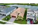Single-story home with a neutral colored exterior, a two-car garage and a brick paved driveway at 32768 Tree Of Life Ave, Wesley Chapel, FL 33543