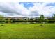 Serene backyard view overlooking a peaceful pond and lush green lawn, perfect for relaxation and outdoor activities at 32768 Tree Of Life Ave, Wesley Chapel, FL 33543