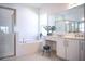 Serene bathroom with a glass-enclosed shower, soaking tub, and a vanity area with ample counter space at 32768 Tree Of Life Ave, Wesley Chapel, FL 33543