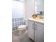 Cozy bathroom featuring modern vanity, toilet, and shower with a patterned curtain, perfect for a guest or secondary bath at 32768 Tree Of Life Ave, Wesley Chapel, FL 33543