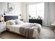Stylish bedroom featuring a tufted headboard, modern lighting, and neutral decor creating a tranquil and inviting space at 32768 Tree Of Life Ave, Wesley Chapel, FL 33543