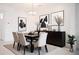 Dining room with modern decor including a black table with seating and stylish artwork adds a sophisticated touch at 32768 Tree Of Life Ave, Wesley Chapel, FL 33543