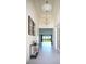 Elegant entryway with high ceilings, stylish decor, and a view of the bright, open living space beyond at 32768 Tree Of Life Ave, Wesley Chapel, FL 33543