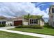 Inviting single-story home featuring a beautiful lawn and a two-car garage at 32768 Tree Of Life Ave, Wesley Chapel, FL 33543