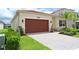 Well-maintained single-story home with a brick paved driveway and a two-car garage at 32768 Tree Of Life Ave, Wesley Chapel, FL 33543