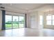 Spacious living area with large sliding glass doors offering scenic backyard views and plenty of natural light at 32768 Tree Of Life Ave, Wesley Chapel, FL 33543