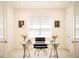 Bright office featuring a modern desk, office chair, window with blinds and matching artwork at 32768 Tree Of Life Ave, Wesley Chapel, FL 33543