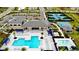 Aerial view of community pool, tennis courts, and playground with seating and manicured lawns at 32768 Tree Of Life Ave, Wesley Chapel, FL 33543
