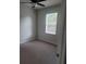 Cozy bedroom with a ceiling fan and large window providing ample natural light, great for or guests at 3312 Lila St, Tampa, FL 33610