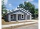 Charming single-story home with a freshly painted exterior, new windows and a well-manicured front yard at 3312 Lila St, Tampa, FL 33610