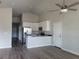 Modern kitchen featuring white cabinets, stainless steel appliances, and a breakfast bar, great for entertaining at 3312 Lila St, Tampa, FL 33610