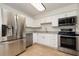 Well-equipped kitchen with stainless steel appliances and sleek white cabinetry at 3555 41St N St, St Petersburg, FL 33713