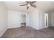 Open living room with neutral carpet and doors that lead to other rooms at 3555 41St N St, St Petersburg, FL 33713