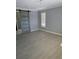 Bedroom with new flooring, a sliding door, and natural light from a window at 3936 48Th S Ave, St Petersburg, FL 33711