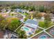 Aerial view of the home, backyard pool, and hot tub, outdoor kitchen, travertine patio and surrounding houses at 4859 Augusta Ave, Oldsmar, FL 34677