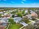 Aerial view of the house nestled in a lush neighborhood with mature trees and a well-maintained lawn at 4859 Augusta Ave, Oldsmar, FL 34677