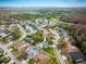 Lovely aerial view of a home with a private pool surrounded by manicured lawns and mature trees near the golf course at 4859 Augusta Ave, Oldsmar, FL 34677